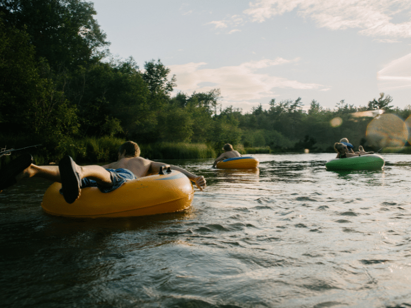 people floating river in tubes