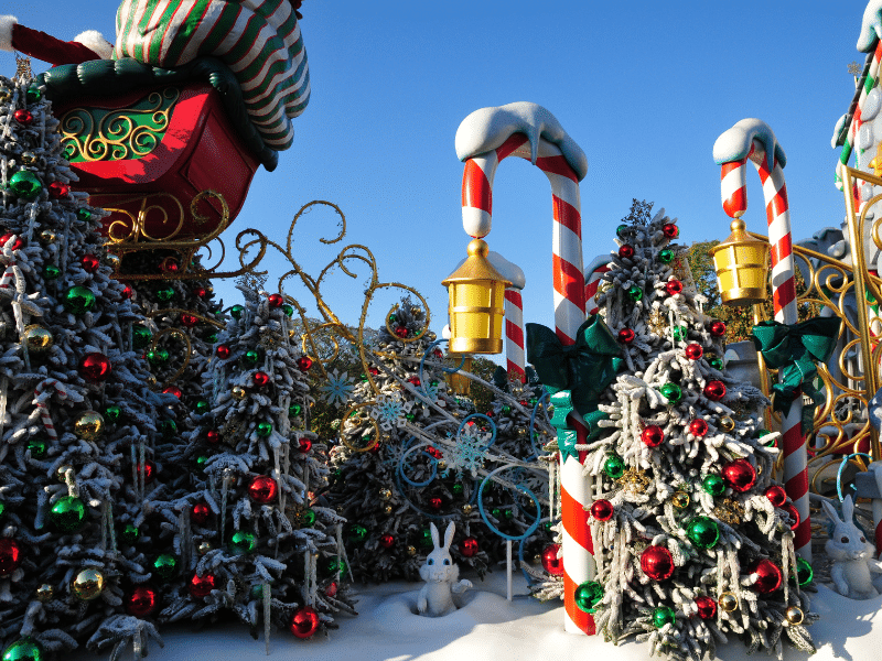 pine trees covered in snow with ornaments and christmas decorations